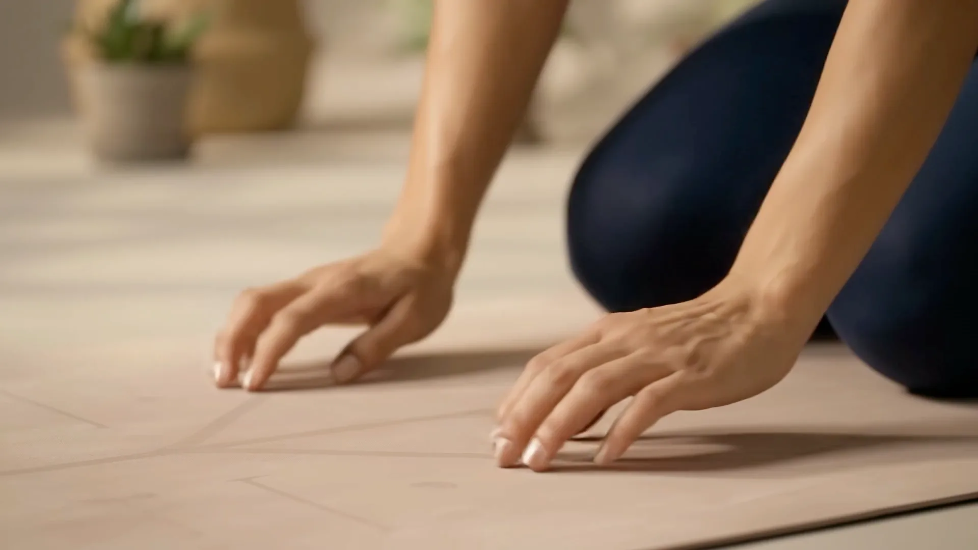 A woman moving through a yoga sequence in a bright, plant-filled studio
